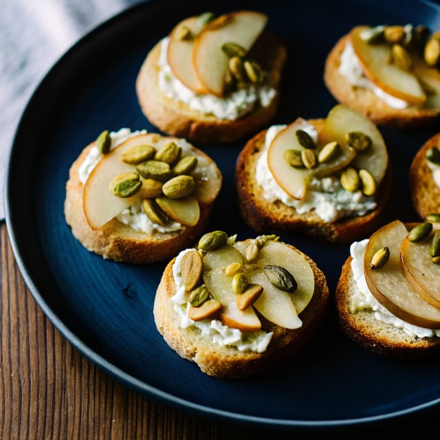 Ricotta and Pear Crostini with Salty Pumpkin Seed Pistachio Crunch